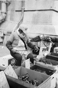 a man in a mask sitting in front of boxes