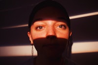 a woman's face with the sun shining on it