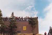 a group of people standing on top of a building